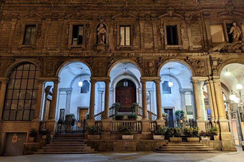 Nächtlich beleuchtete Häuserfassade auf der Piazza Mercanti