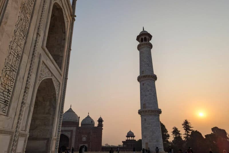 Aufgehende Sonne neben einem Minarett des Taj Mahals